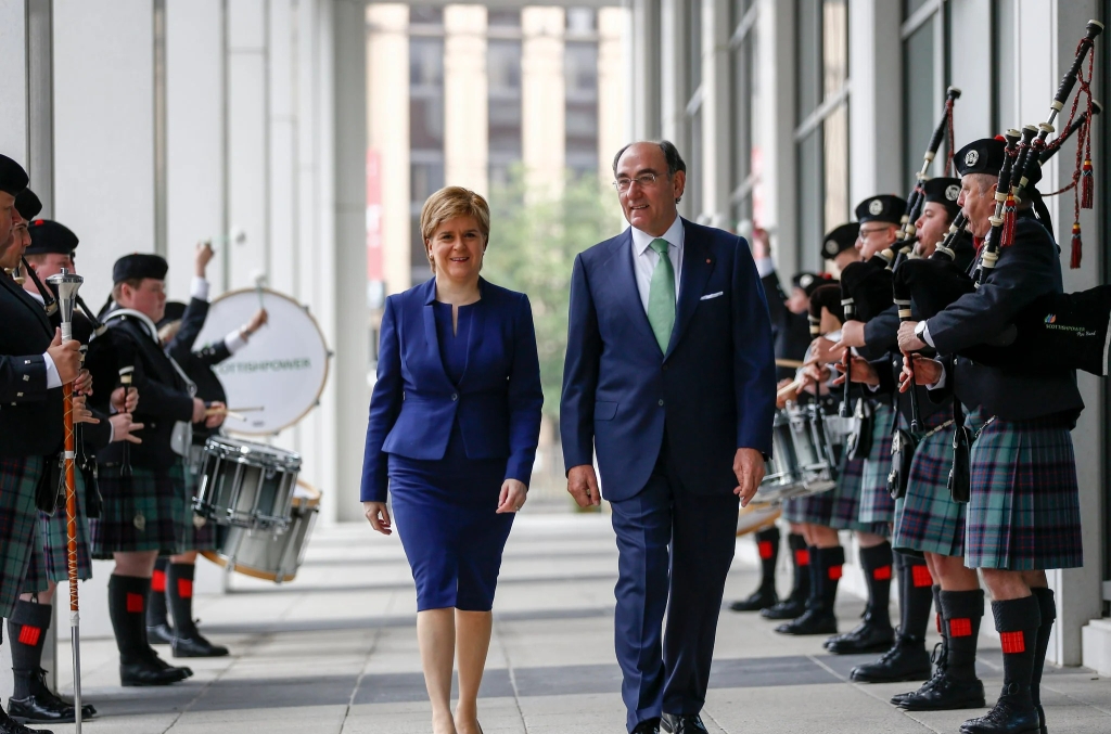 Photograph of Nicola Sturgeon at a cultural event in Glasgow in 2017, walking in between a Scottish marching band.